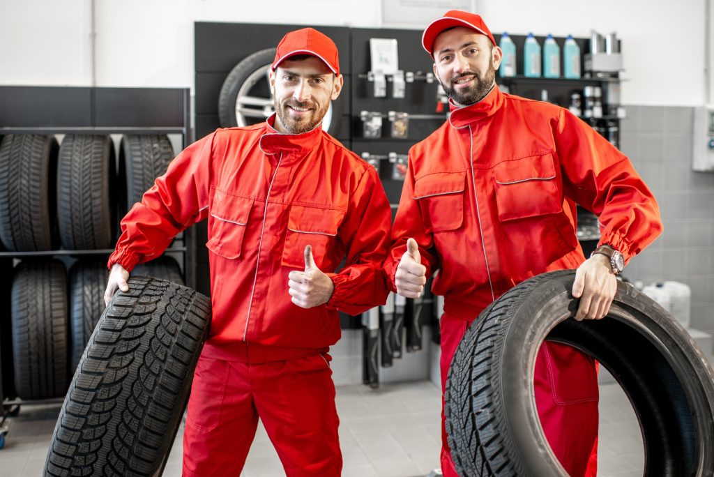 Emergency and Call-Out Tyre Services in Bristol: Rapid Response from Fast Grip 3 car service workers with new tires at the shop
