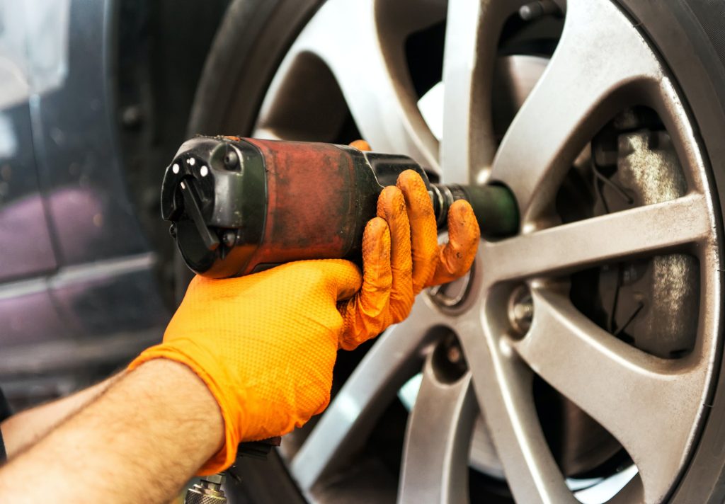 Specific Vehicle Tyre Services in Bristol: Tailored Solutions from Fast Grip 9 mechanic unscrewing car wheel with impact wrench