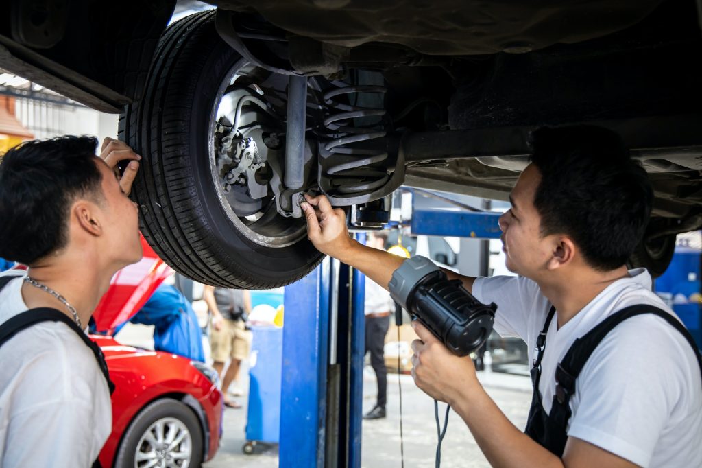 Wheel Alignment Guide: Keep Your Vehicle Running Smoothly with Fast Grip Mobile Tyres 4 two mechanic was checking the car suspension