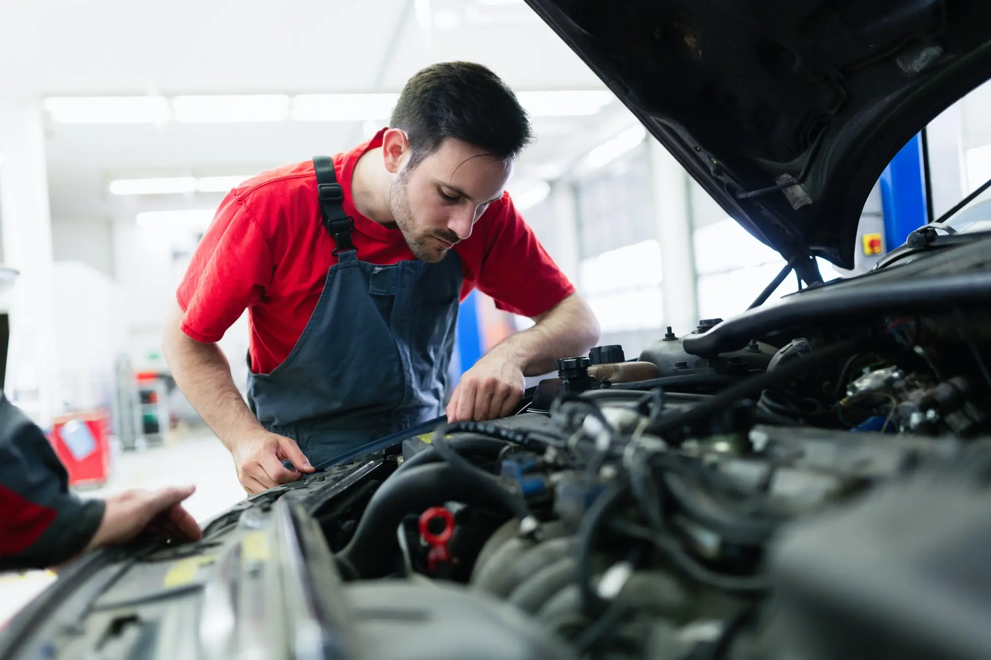 car mechanic working at automotive service center in Bristol UK